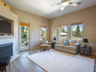 Experience comfortable living in this inviting living room, featuring a cozy fireplace and a large TV for entertainment.