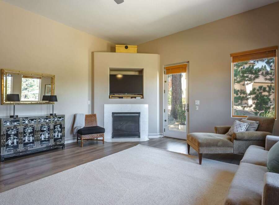 This inviting living room features a modern fireplace with a mounted television, perfect for cozy evenings.