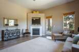This inviting living room features a modern fireplace with a mounted television, perfect for cozy evenings.