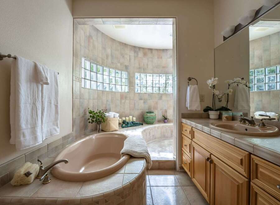 Indulge in luxury with this stunning bathroom featuring a spacious, built-in bathtub perfect for relaxation.