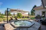 Experience ultimate relaxation in this backyard oasis, featuring a luxurious octagonal hot tub perfect for unwinding.