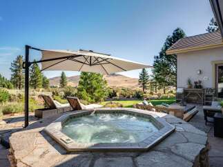 Experience ultimate relaxation in this backyard oasis, featuring a luxurious octagonal hot tub perfect for unwinding.