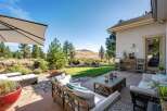 Enjoy outdoor living with this spacious patio featuring comfortable seating and a coffee table, perfect for entertaining.