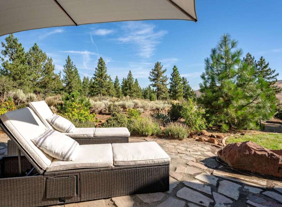 Relax and unwind in this serene outdoor oasis, featuring comfortable lounge chairs perfect for soaking up the sun or enjoying the picturesque landscape.