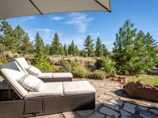 Relax and unwind in this serene outdoor oasis, featuring comfortable lounge chairs perfect for soaking up the sun or enjoying the picturesque landscape.
