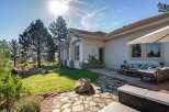 Enjoy outdoor living with this spacious patio featuring comfortable seating and a large umbrella for shade.