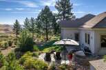 Experience luxurious outdoor living with this stunning backyard oasis, featuring a relaxing hot tub and comfortable lounge chairs perfect for soaking up the sun.