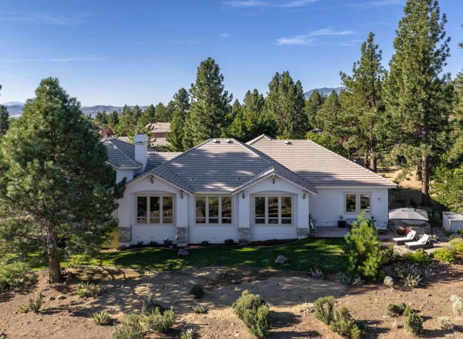 This stunning single-story home offers a luxurious retreat surrounded by mature pine trees and breathtaking mountain views.