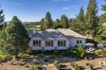 This stunning single-story home offers a luxurious retreat surrounded by mature pine trees and breathtaking mountain views.