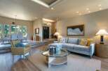 Experience elegant living in this spacious home, featuring a sophisticated living area with a plush sectional sofa and a stylish coffee table.