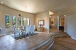 Experience elegant dining in this spacious room featuring a glass-top dining table with upholstered chairs, perfect for hosting gatherings.