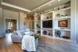 Step into this inviting living room featuring a spacious sectional sofa adorned with decorative pillows and a cozy knit throw.
