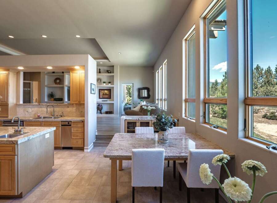 Experience breathtaking views from this stunning home, featuring a spacious open-concept kitchen and dining area perfect for entertaining.