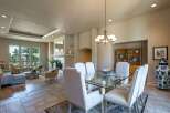 Experience elegant dining in this spacious room, featuring a glass-top dining table with comfortable upholstered chairs, perfect for hosting gatherings.