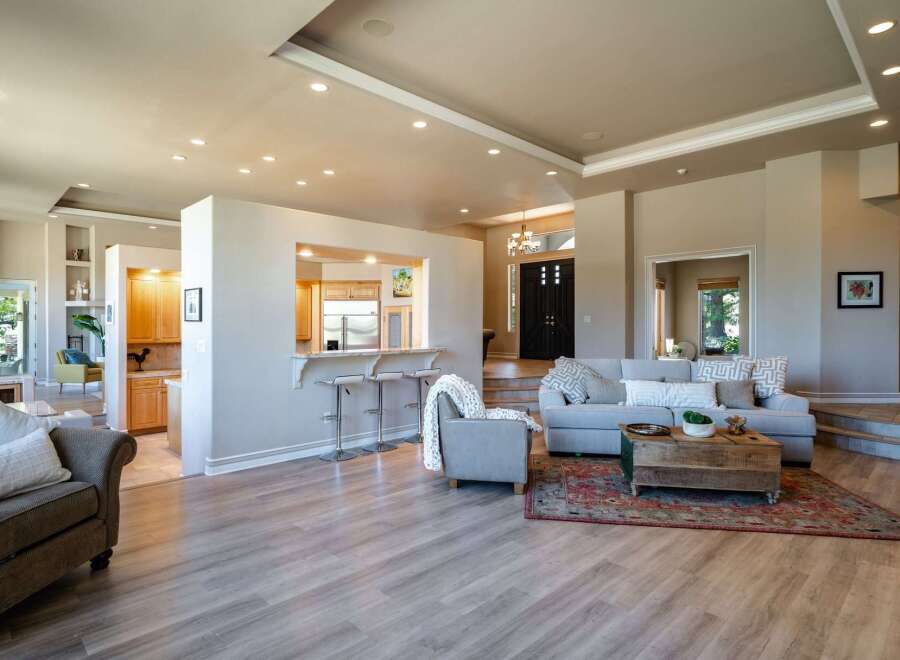 Experience open-concept living in this stunning home, seamlessly blending a modern kitchen with a spacious living area.