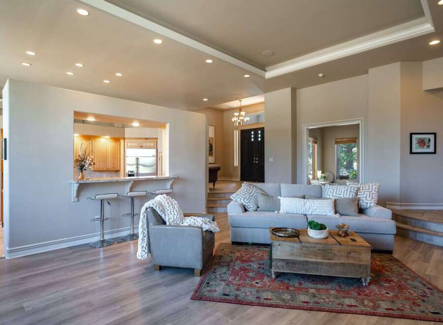 Experience open-concept living in this beautifully appointed home, featuring a seamless flow between the living area and a modern kitchen with a convenient breakfast bar.