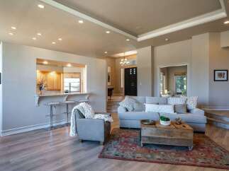Experience open-concept living in this beautifully appointed home, featuring a seamless flow between the living area and a modern kitchen with a convenient breakfast bar.