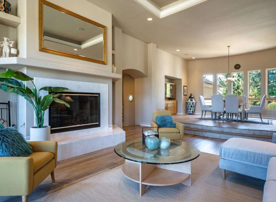 Experience elegant living in this spacious home featuring a grand fireplace and a formal dining area perfect for entertaining.