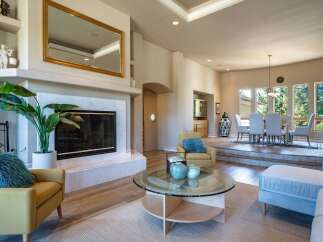 Experience elegant living in this spacious home featuring a grand fireplace and a formal dining area perfect for entertaining.