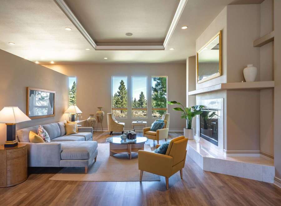 Experience luxurious living in this stunning living room, featuring a spacious sectional sofa and comfortable accent chairs perfect for relaxation.