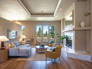 Experience luxurious living in this stunning living room, featuring a spacious sectional sofa and comfortable accent chairs perfect for relaxation.