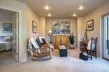 This inviting living space features two comfortable wooden rocking chairs adorned with cozy throws and pillows, perfect for relaxation.