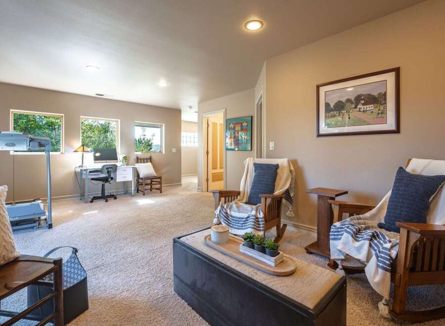 This versatile room offers a dedicated workspace with a desk and computer, perfect for home office needs.