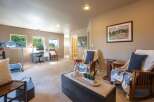 This versatile room offers a dedicated workspace with a desk and computer, perfect for home office needs.