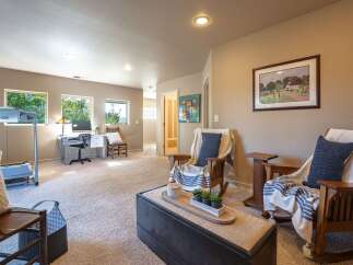 This versatile room offers a dedicated workspace with a desk and computer, perfect for home office needs.