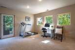 This versatile room offers a perfect blend of fitness and productivity, featuring a treadmill for your workouts and a dedicated desk space with a computer for work.