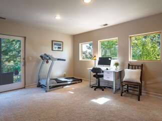 This versatile room offers a perfect blend of fitness and productivity, featuring a treadmill for your workouts and a dedicated desk space with a computer for work.