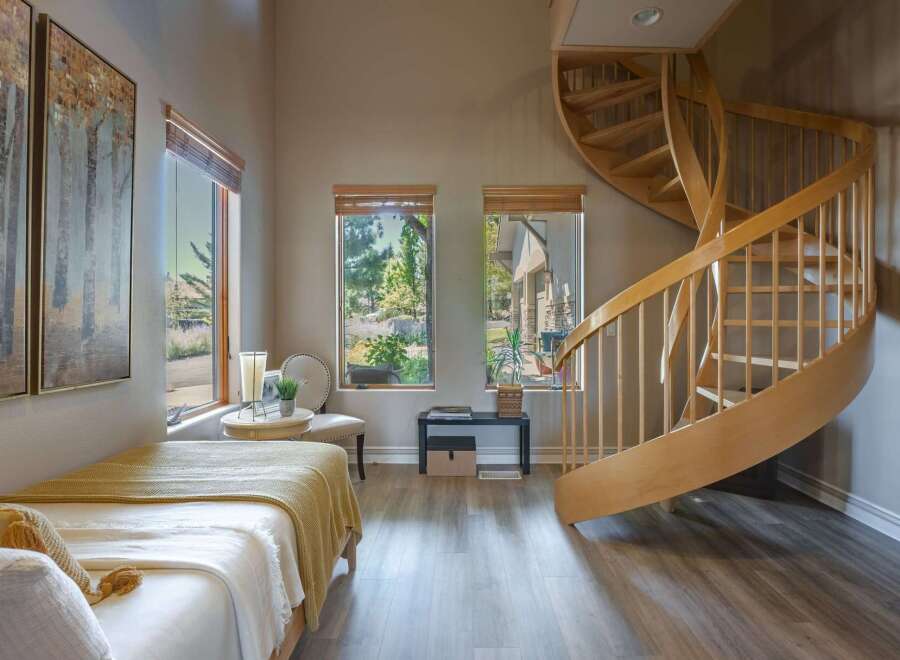 Discover this charming room featuring a cozy bed adorned with a yellow throw, perfect for relaxation.