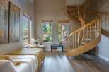 Discover this charming room featuring a cozy bed adorned with a yellow throw, perfect for relaxation.