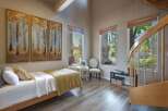 This charming bedroom features a cozy twin bed adorned with a yellow knit blanket and white linens, perfect for relaxation.