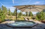 Indulge in ultimate relaxation with this luxurious outdoor hot tub, perfectly situated amidst a serene natural landscape.