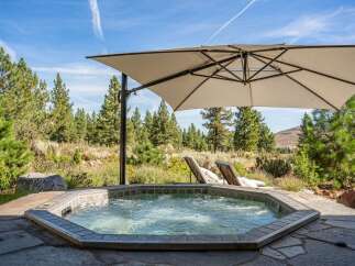 Indulge in ultimate relaxation with this luxurious outdoor hot tub, perfectly situated amidst a serene natural landscape.