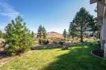 Experience the serene beauty of this property, featuring a lush green lawn that seamlessly transitions into a natural landscape.