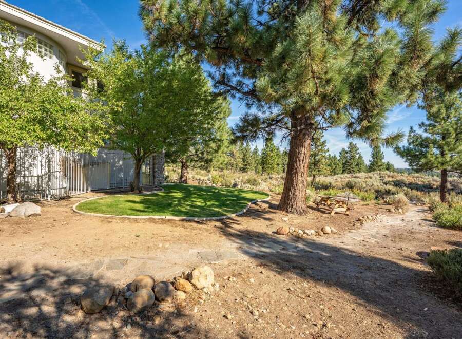 Enjoy the serene outdoor living space with a lush green lawn, perfect for relaxation and recreation.