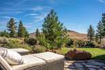 Enjoy breathtaking mountain views from this stunning outdoor living space, complete with comfortable chaise lounges perfect for soaking up the sun.