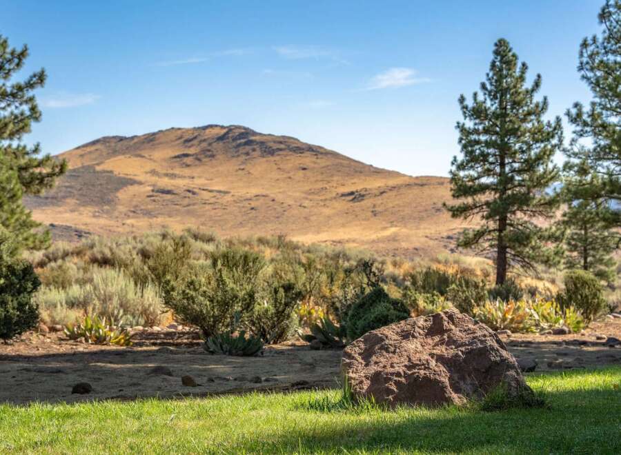 Discover a serene landscape with a majestic mountain backdrop, perfect for a tranquil retreat.