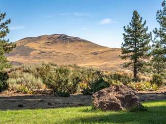 Discover a serene landscape with a majestic mountain backdrop, perfect for a tranquil retreat.