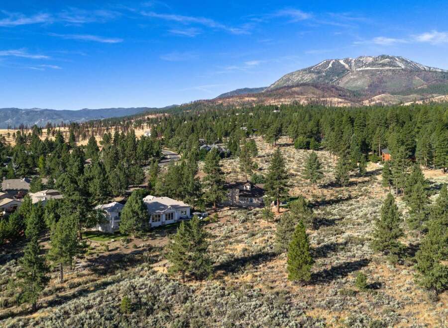 Discover this stunning property nestled amidst a picturesque landscape of mature pine trees and rolling hills.