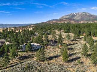 Discover this stunning property nestled amidst a picturesque landscape of mature pine trees and rolling hills.