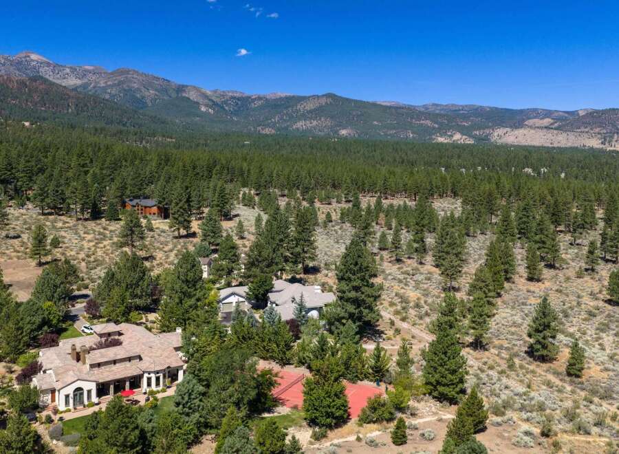 Discover this stunning mountain estate nestled amidst a lush pine forest, offering unparalleled privacy and breathtaking views.