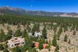 Discover this stunning mountain estate nestled amidst a lush pine forest, offering unparalleled privacy and breathtaking views.