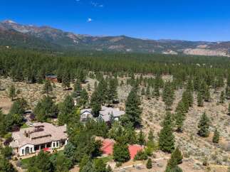 Discover this stunning mountain estate nestled amidst a lush pine forest, offering unparalleled privacy and breathtaking views.