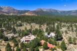 Nestled amidst a lush pine forest with stunning mountain views, this expansive estate offers unparalleled privacy and luxury.