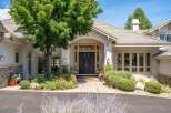 Discover this stunning home featuring a grand entrance with elegant double doors and large windows.