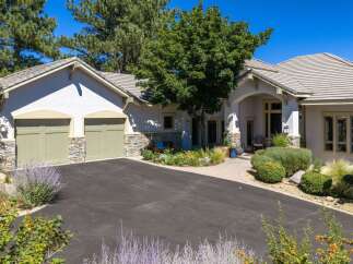 Discover this stunning home featuring a welcoming driveway leading to a charming entrance.