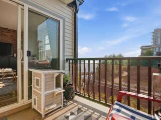 Enjoy your morning coffee on this charming balcony with a scenic view of the water and city skyline.